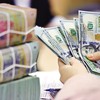Lãi suất huy động tăng, tỷ giá hạ nhiệt