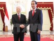 Tổng thống Indonesia Joko Widodo đón Tổng Bí thư Nguyễn Phú Trọng (Ảnh: Trí Dũng/TTXVN)