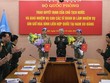 Thượng tướng Nguyễn Chí Vịnh trao quyết định và chúc mừng 2 sĩ quan lên đường làm nhiệm vụ. Ảnh BQP.