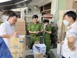Lực lượng công an kiểm đếm số lượng hàng hóa nghi vấn nhập lậu. (Ảnh: TTXVN phát)