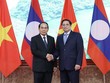 Thủ tướng Phạm Minh Chính nhiệt liệt chào mừng đồng chí Bounthong Chitmany sang thăm chính thức Việt Nam. (Ảnh: Nhật Bắc)