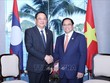 Thủ tướng Phạm Minh Chính gặp Thủ tướng Lào Sonexay Siphandone. Ảnh: Dương Giang/TTXVN