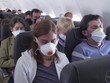 Hành khách hàng không đeo khẩu trang để ngừa Covid-19 khi đi máy bay. Ảnh: CNN.