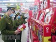 Lực lượng quản lý thị trường kiểm tra hàng hóa. (Ảnh: Trần Trang/TTXVN).