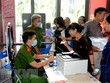 Công an làm căn cước công dân gắn chíp cho người dân tại điểm dịch vụ công trực tuyến. (Ảnh: Thành Chung/TTXVN)