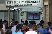 Một quầy đổi tiền ở Singapore. (Nguồn: AFP/TTXVN)