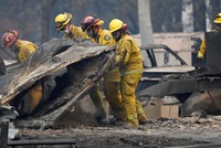 Lực lượng tìm kiếm người sống sót trong vụ cháy rừng Camp ở California hôm 13/11. Ảnh: AP.