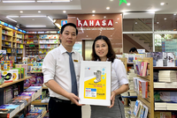 Đại diện nhà sách Fahasa Tân Bình (bên trái) nhận Máy phun gel rửa tay tự động từ đại diện công ty Thiên Long Hoàn Cầu – công ty thành viên của Tập đoàn Thiên Long.