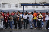 Người dân chờ xe buýt ở Caracas. Ảnh: AP.