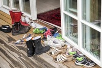 Tháo giày trước khi vào nhà để tránh mang những vi khuẩn gây bệnh vào trong nhà. Ảnh: KP.