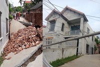 Hình ảnh con đường bị sụt sâu xuống 3-4m cùng ngôi nhà bị lún (Ảnh: Nguyễn Kim Tuấn/Vietnam+).