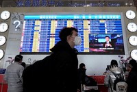 Hành khách đeo khẩu trang tại sân bay Bắc Kinh. (Ảnh: Reuters).