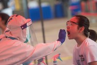 Nhân viên y tế lấy mẫu xét nghiệm COVID-19 cho trẻ nhỏ tại Vũ Hán, tỉnh Hồ Bắc, Trung Quốc ngày 15/5 vừa qua. (Ảnh: THX/TTXVN).