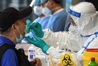 Nhân viên y tế lấy mẫu xét nghiệm nCoV cho một người dân ở thành phố Nam Kinh, tỉnh Giang Tô, Trung Quốc, ngày 15/6. Ảnh: AFP.
