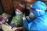 Tiêm vaccine cho người già yếu tại nhà. (Ảnh TTXVN phát).