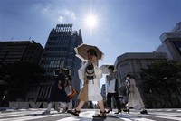 Người dân di chuyển dưới tiết trời nắng nóng tại Nagoya, Nhật Bản, ngày 1/7/2022. (Ảnh: Kyodo/TTXVN).