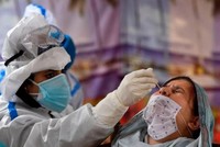 Nhân viên y tế lấy mẫu xét nghiệm tại một trung tâm xét nghiệm Covid-19 ở thành phố Srinagar, Ấn Độ. Ảnh: AFP