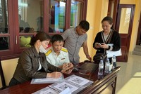 Công chức Thuế tỉnh Lạng Sơn hỗ trợ hộ kinh doanh kê khai thuế thu nhập. Ảnh: HV.