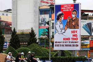 Áp phích phòng chống Covid-19 được treo ở nhiều tuyến đường để nâng cao ý thức người dân.