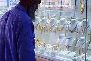Ảnh người công nhân vệ sinh ở thủ đô Arab Saudi nhìn chăm chú vào trang sức bày trong cửa tiệm bị chế nhạo trên mạng xã hội. Ảnh: Twitter