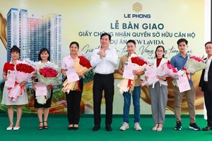 Đại diện Tập đoàn Lê Phong trao giấy chứng nhận quyền sở hữu căn hộ và hoa cho cư dân.