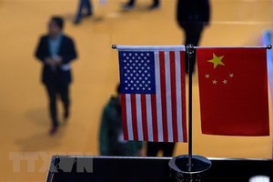 Cờ Mỹ (trái) và cờ Trung Quốc (phải). (Ảnh: AFP/TTXVN).
