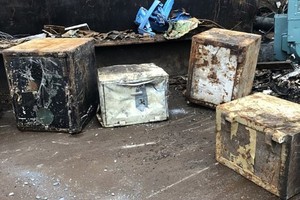 Bốn chiếc két sắt bỏ hoang được những nhân viên của một cửa hàng Scrapyard tái chế.