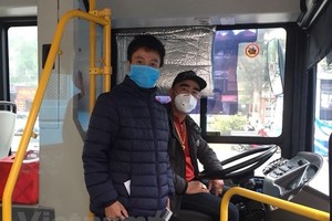 Tài xế và nhân viên phụ xe buýt tại Hà Nội đeo khẩu trang phòng chống dịch COVID-19. (Ảnh: CTV/Vietnam+).