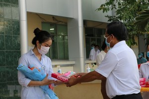 Trao quà và trao giấy xuất viện cho trường hợp mắc COVID-19 sau thời gian điều trị, tại Bệnh viện Đa khoa Sa Đéc, Đồng Tháp. (Ảnh: Chương Đài/TTXVN).