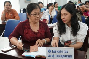 Viên chức BHXH TP.HCM tư vấn, hướng dẫn người dân sử dụng ứng dụng VssID.