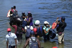 Người di cư băng qua sông ở bang Coahuila, Mexico. (Ảnh: AFP/TTXVN).