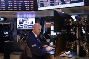 Kết quả kinh doanh tác động trái chiều lên phố Wall (Ảnh minh họa: AFP)