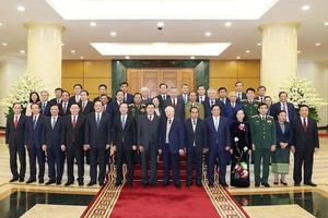 Tổng Bí thư Nguyễn Phú Trọng và Tổng Bí thư, Chủ tịch nước Lào Thongloun Sisoulith cùng các đại biểu Việt Nam - Lào chụp ảnh chung. (Ảnh: Trí Dũng/TTXVN)