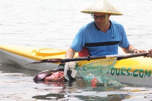 Du khách nước ngoài trải nghiệm tour du lịch dọn sạch bãi biển tại Vân Đồn (Quảng Ninh). (Ảnh: AEEC)