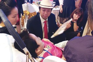 Phạm Đình Nguyên (đội mũ trắng, ngồi giữa) trong một buổi giao lưu với “cô gái xương thủy tinh” Nguyễn Thị Thu Thương, Giám đốc Trung tâm Dạy nghề và đào tạo việc làm Thương Thương