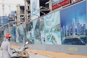 Một khách hàng tiềm năng đang xem các thông tin quảng cáo trước Dự án HPC Landmark 105 trên đường Tố Hữu, quận Hà Đông