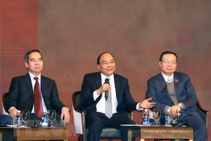 Thủ tướng Nguyễn Xuân Phúc đối thoại tại Diễn đàn kinh tế Việt Nam năm 2018. (Ảnh: Thống Nhất/TTXVN)