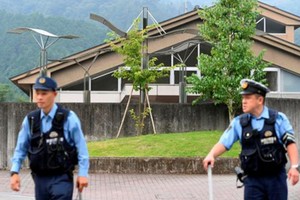 Cảnh sát Nhật canh gác bên ngoài hiện trường. Ảnh: Reuters