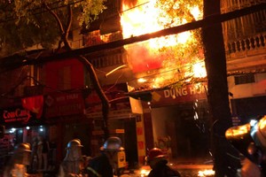 Ngọn lửa lan rộng ra nhiều cửa hàng gần bệnh viện Nhi Trung ương. Ảnh: Ngọc Thành.