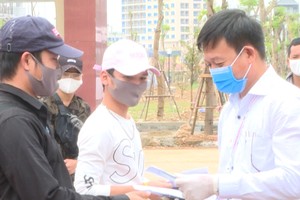 Bác sĩ Đỗ Quốc Tiệp, Giám đốc Trung tâm Kiểm soát bệnh tật tỉnh Quảng Bình trao giấy chứng nhận cho các công dân đã hoàn thành thời gian cách ly y tế.