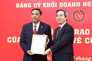 Đồng chí Nguyễn Văn Bình, Ủy viên Bộ Chính trị, Bí thư Trung ương Đảng, Trưởng ban Kinh tế Trung ương trao quyết định cho đồng chí Hoàng Giang.