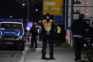 Một cảnh sát Đức đứng gác tại khu vực kiểm soát phương tiện giữa thành phố Kehl, Đức và Strasbourg, Pháp ngày 12/3. Ảnh: AFP.