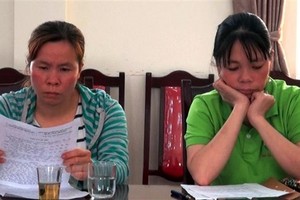 Nguyễn Thị Hồng Tươi và Nguyễn Thị Lan tường trình sự việc tại trụ sở Công an huyện Than Uyên (Lai Châu). (Ảnh: TTXVN phát).