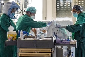 Các nhân viên y tế điều trị cho bệnh nhân nhiễm nCoV tại một bệnh viện ở Rome, Italy, ngày 21/4. Ảnh: AFP.