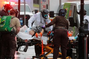 Nhân viên y tế đưa bệnh nhân Covid-19 lên xe cứu thương tại thành phố Boston, bang Massachusetts, Mỹ hôm 27/4. Ảnh: Reuters.