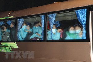 Tiếp nhận công dân trở về từ Malaysia. (Ảnh: Huỳnh Phúc Hậu/TTXVN).