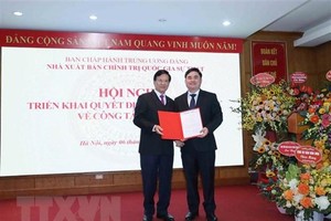 Ông Hà Ban, Ủy viên Trung ương Đảng, Phó Trưởng Ban Tổ chức Trung ương trao quyết định bổ nhiệm ông Phạm Minh Tuấn giữ chức Giám đốc kiêm Tổng Biên tập Nhà xuất bản Chính trị quốc gia Sự thật. (Ảnh: Phương Hoa/TTXVN).