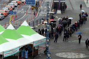 Người dân xếp hàng chờ lấy mẫu xét nghiệm COVID-19 tại Seoul, Hàn Quốc ngày 26/1/2021. (Ảnh: Yonhap/TTXVN).