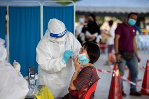 Nhân viên y tế lấy mẫu xét nghiệm COVID-19 cho người dân tại Selangor, Malaysia ngày 23/5/2021. (Ảnh: THX/TTXVN).