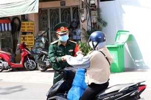 Cán bộ, chiến sỹ Bộ Tư lệnh Thành phố Hồ Chí Minh tham gia công tác kiểm soát thực hiện Chỉ thị 16 trên địa bàn Thành phố. (Ảnh: Xuân Khu/TTXVN).